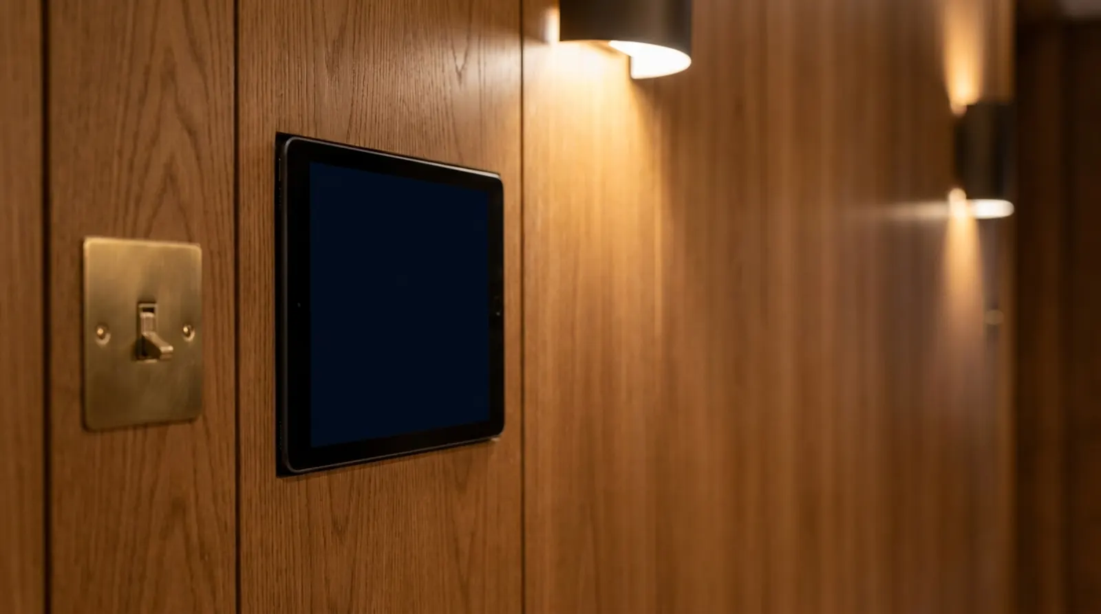 A slim control tablet set into a wall